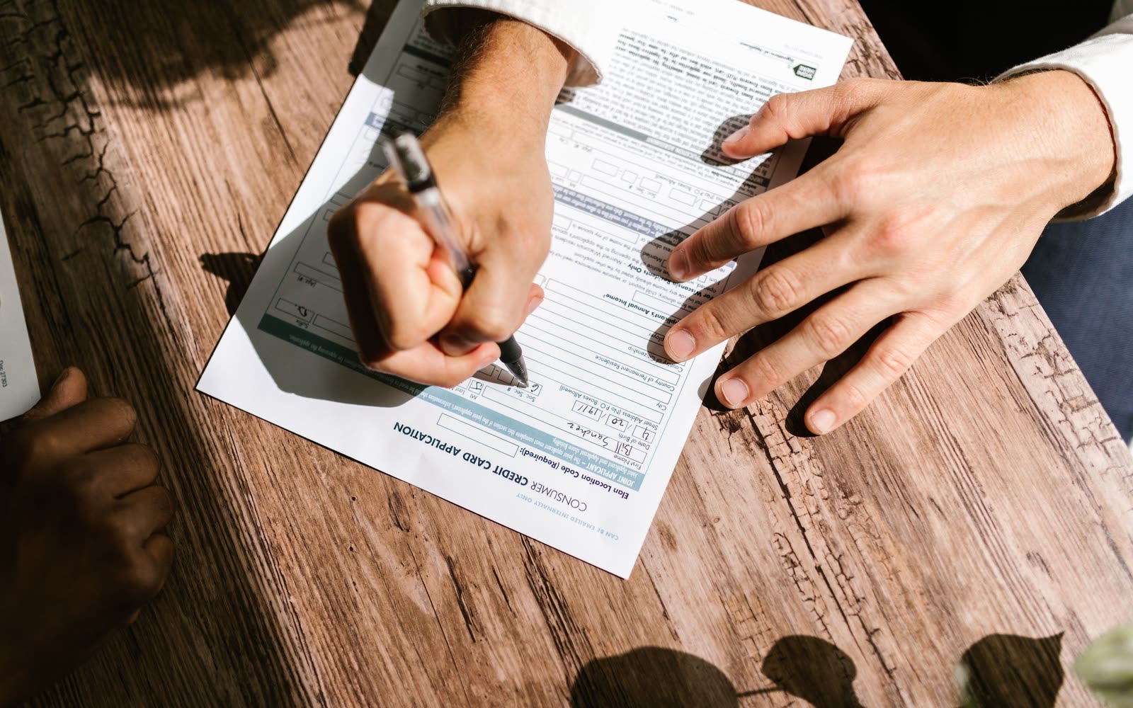 A loan application and closing paperwork on a table