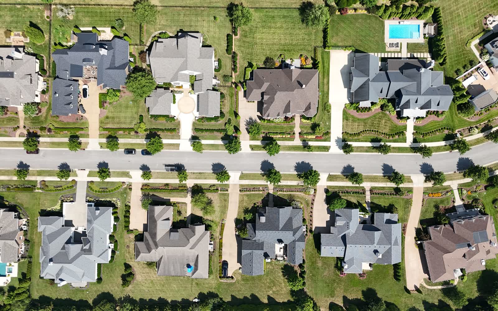 Rows of suburban homes and lawns seen from above