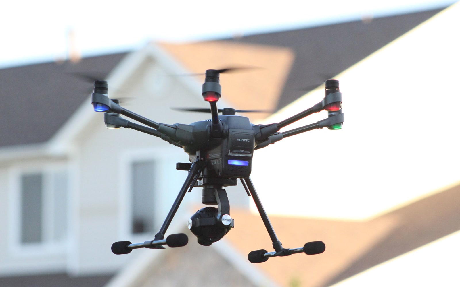 A camera drone hovering in front of a house