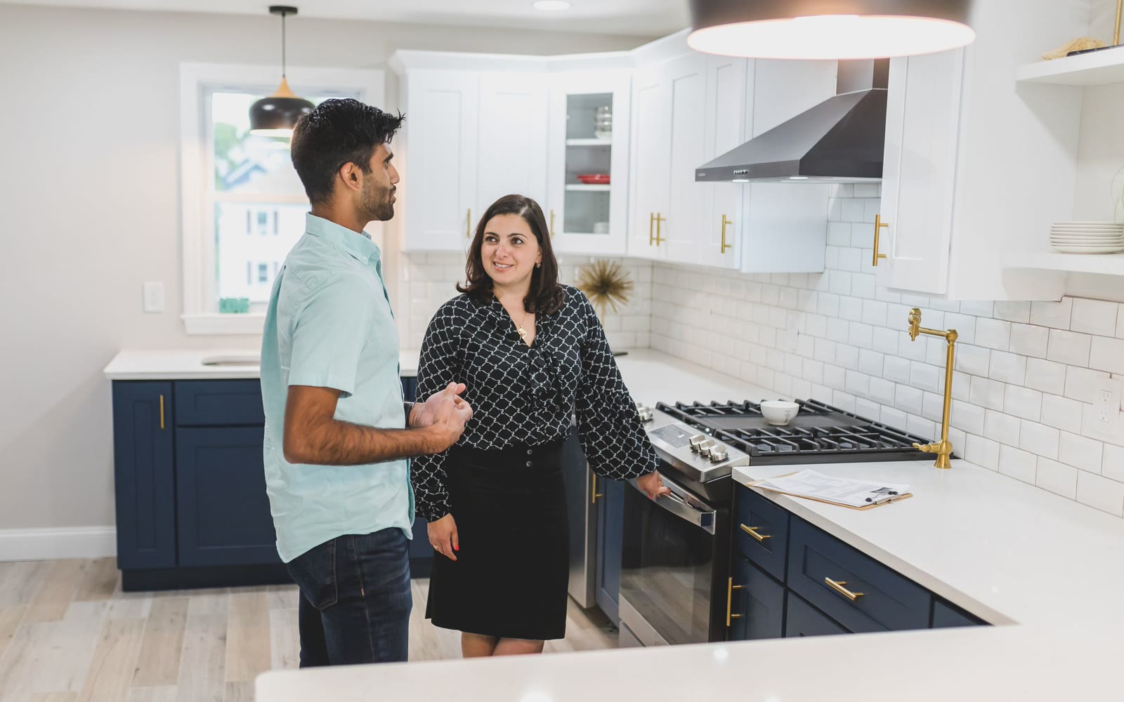 A couple looking around the kitchen of a house before closing